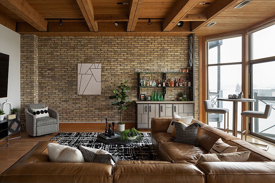 This industrial living room makeover in a loft uses warm colors to work with the cold concrete and dusting that can be part of loft living.